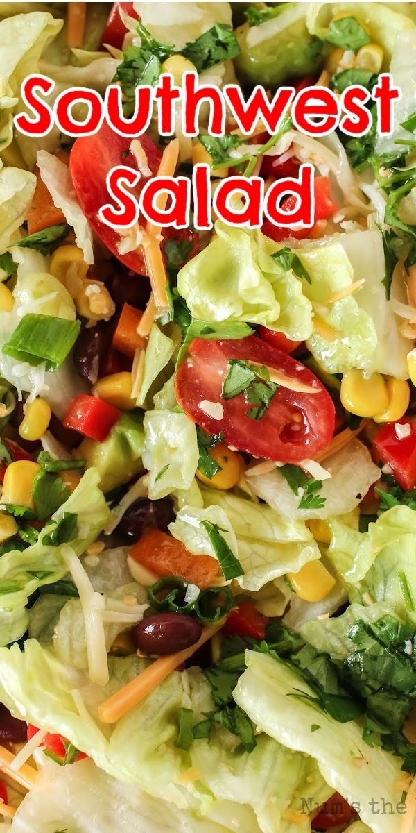 a salad with lettuce, tomatoes, corn and black olives in it