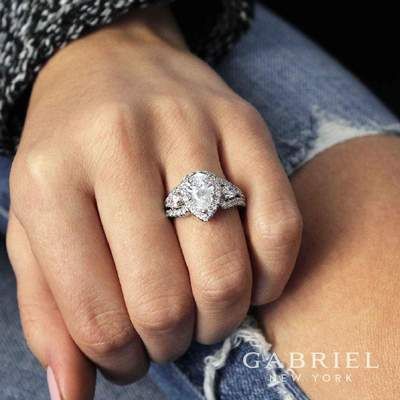 a woman's hand with a diamond ring on it