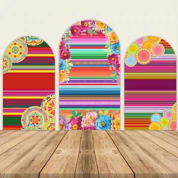 an empty wooden table in front of three colorful wall hangings with flowers on them