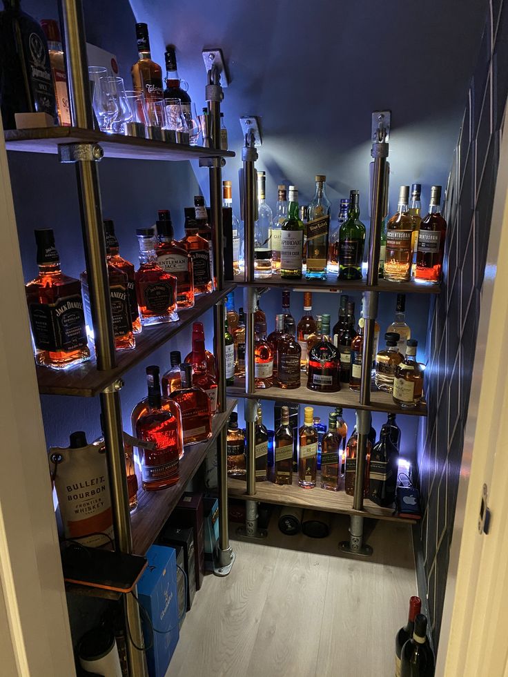 the shelves are filled with bottles of liquor