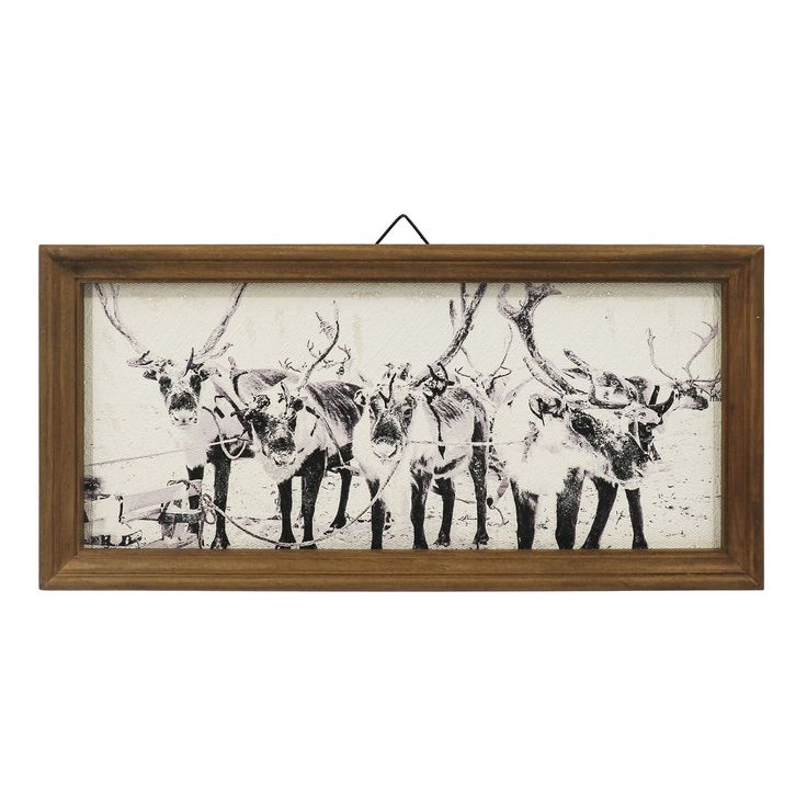 a framed painting with three deers on it's back and one standing in the middle