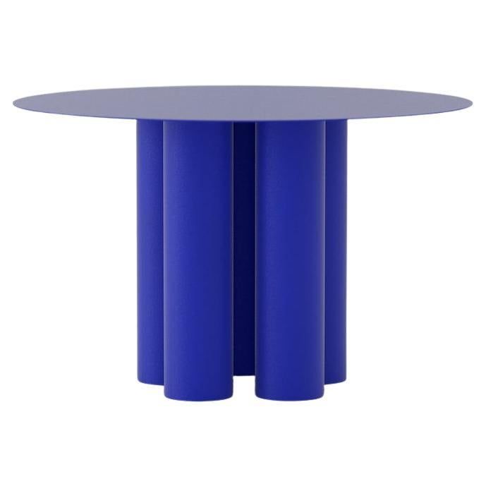 a round table with two blue columns in the middle