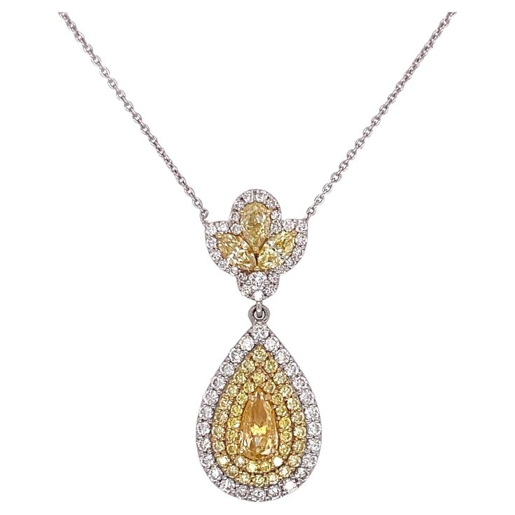 Teardrop diamond pendant necklace in 18K white gold. The pendant features 1.54ctw of yellow pear shape and round diamonds, and 0.46ctw of round white diamonds. The chain can be worn at a 18" or 16" length. White Diamond Necklace, Teardrop Diamond, Pear Pendant, Womens Jewelry, Teardrop Pendant, Modern Necklaces, Diamond Pendant Necklace, Yellow Diamond, White Diamonds