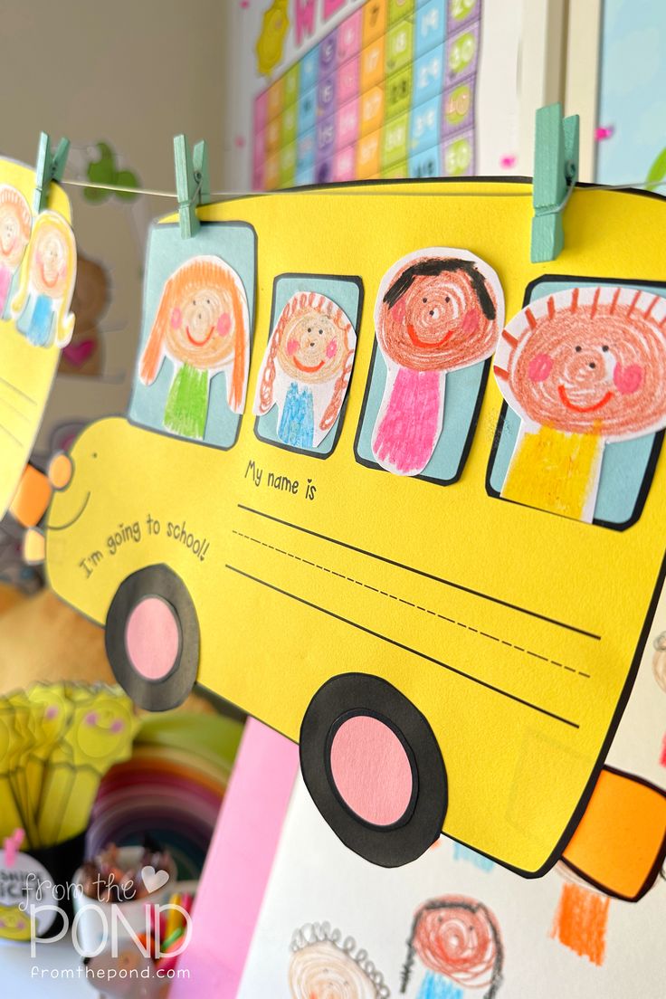 children's artwork hanging from clothes pins on a school bus