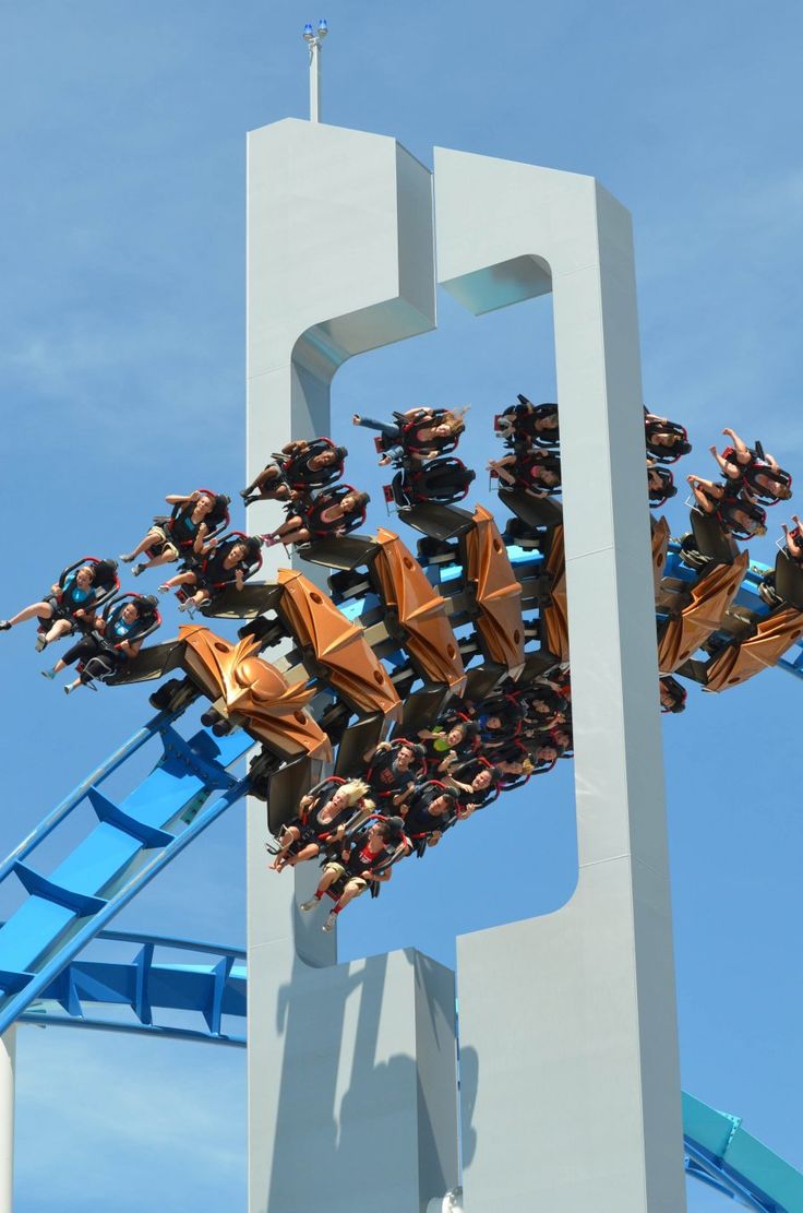 an amusement park ride with people riding on it's roller coasters in the sky