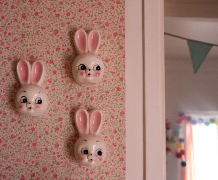 three bunny head magnets mounted to the side of a wall