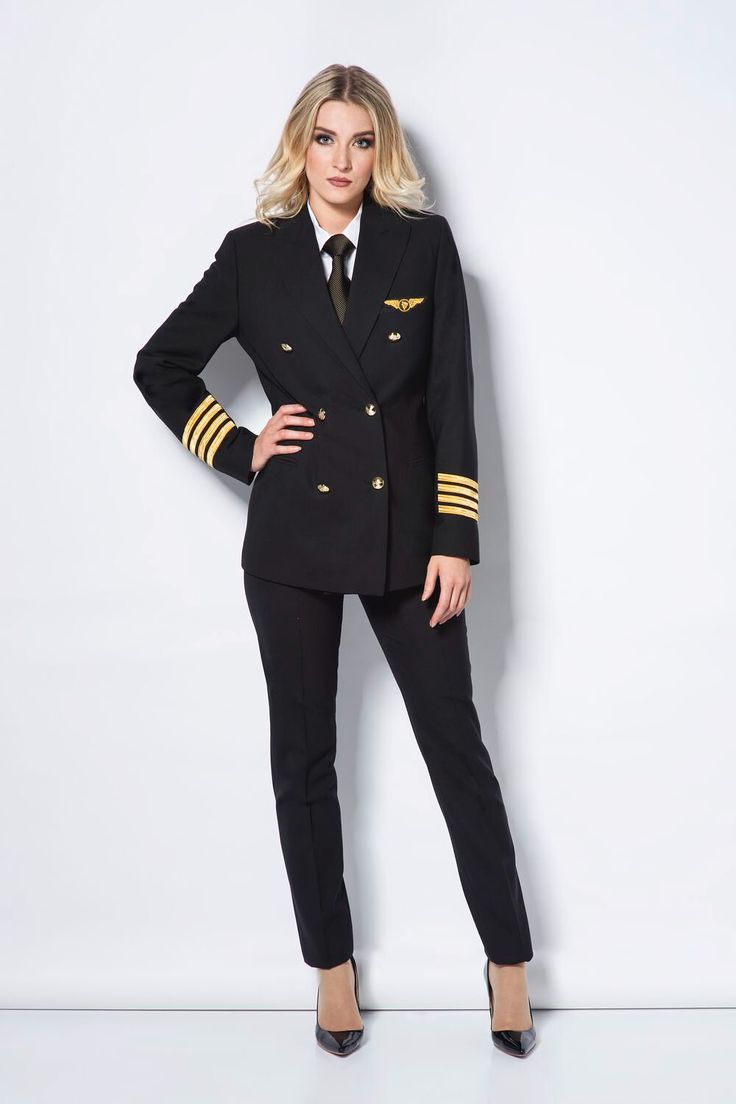 a woman in an air force uniform posing for the camera with her hands on her hips