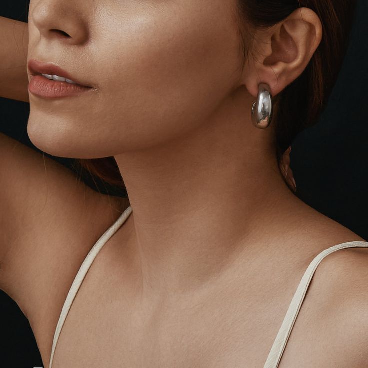 The Patricia Earrings from our Liza Collection were designed for confident women everywhere. Handcrafted with imitation rhodium tin alloy and measuring 1'' in length and 3/4'' in width, these post earrings are the perfect, show-stopping silver-tone hoops for any ensemble. These earrings are made to order in our New York City Design Studio. Please allow 7-14 business days for production before the ship date. Classic Sterling Silver Clip-on Earrings, Timeless Silver Drop Hoop Earrings, Elegant Silver Hoop Clip-on Earrings, Minimalist Metal Clip-on Earrings, Timeless Silver Tarnish Resistant Hoop Earrings, Elegant Silver Earrings For Everyday, Modern Hoop Clip-on Earrings, Elegant Everyday Silver Earrings, Timeless Silver Drop Earrings