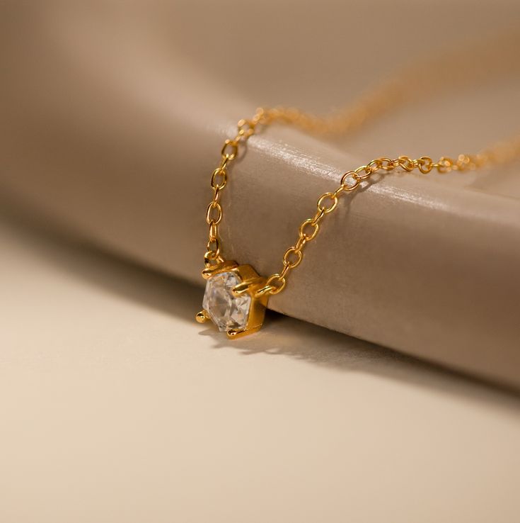 Explore modern elegance with our Hexagon Diamond Necklace, featuring a captivating rose-cut diamond at its core. This dainty and geometric piece effortlessly combines sophistication with contemporary charm, offering a unique allure for any occasion. Material: High Quality 925 Solid Sterling Silver Finish: 18K Gold ∙ Sterling Silver Featuring a ~4.5mm x 4mm Hexagonal Rose-Cut CZ Diamond Charm on a dainty Cable Chain, adjustable from 16 to 18 inches Part of our Diamond & Pavé Collection SKU: RR-NR Modern Solitaire Diamond Cut Necklace For Gift, Elegant Everyday Diamond-shaped Jewelry, Elegant Diamond White Octagon Necklace, Modern Yellow Gold Solitaire Necklace As Gift, Modern Yellow Gold Solitaire Necklace Gift, Octagon Necklace For Wedding, Elegant Hexagon Diamond Cut Jewelry, Diamond Cut Octagon Necklace, Minimalist Faceted Diamond Jewelry