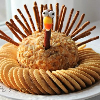 a plate with crackers, crackers and a fake turkey on top of it