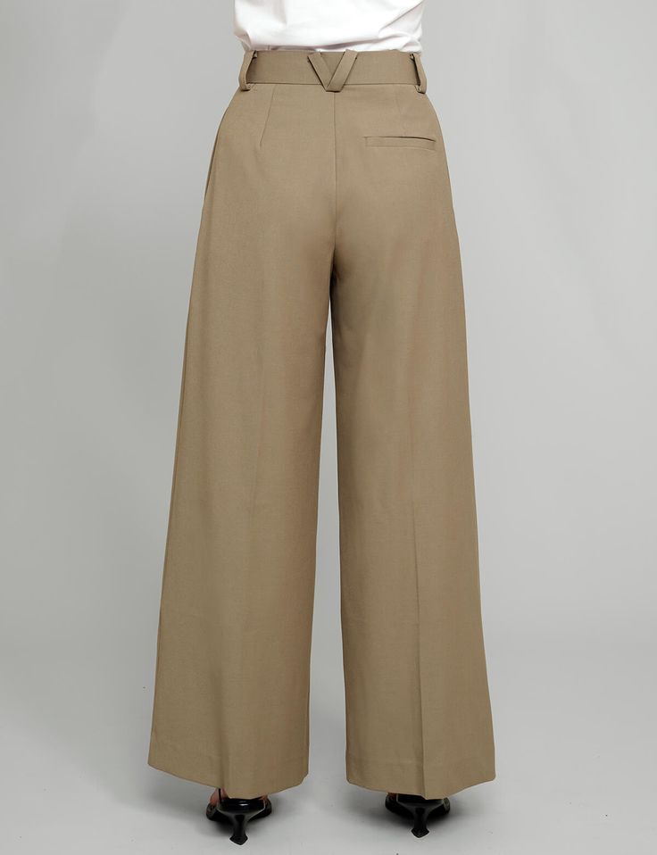 Tan high-waisted pants . Styled with Olympia Tee . 80% polyester, 20% rayonSide pocketsBack faux pocket Size S waist 26.5", hips 37", length 41" Inseam 30" Size M waist 28", hips 39", length 42" Inseam 30.5Size L waist 29.5", hips 40", length 43" inseam 31" Model wears size S and is 5.8"/ 170 cm Imported Fitted Wide Leg Bottoms With Belt Loops, Solid Wide Leg Pants With Welt Pockets, Relaxed Fit High Waist Bottoms With Side Pockets, High Waist Relaxed Fit Bottoms With Side Pockets, High Waist Bottoms With Belt Loops, High Waist Bottoms With Side Pockets And Relaxed Fit, Fall Wide Leg Bottoms With Pockets, Wide Leg Dress Pants With Welt Pockets, Tailored Solid Color Wide Leg Full Length Pants