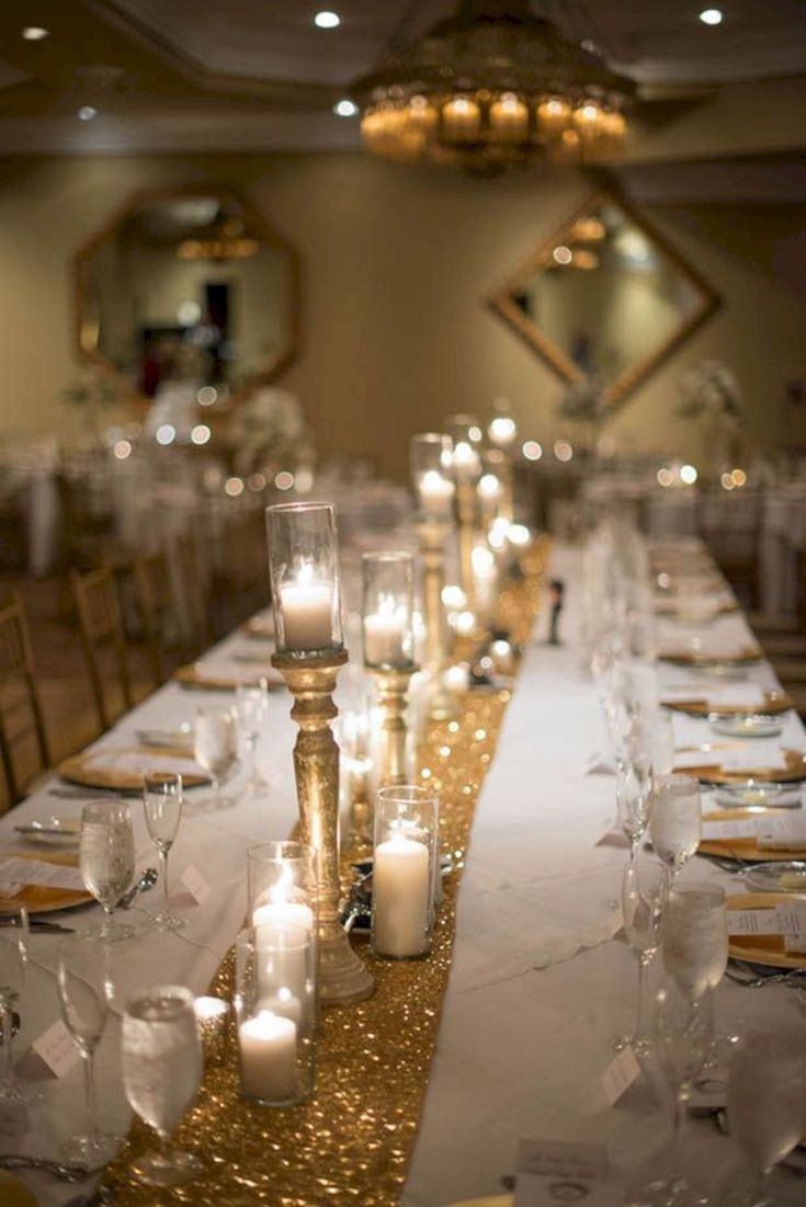 a long table is set with candles and place settings