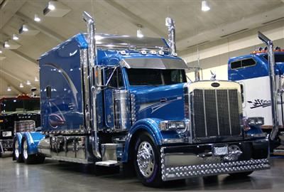 a large blue semi truck parked in a garage