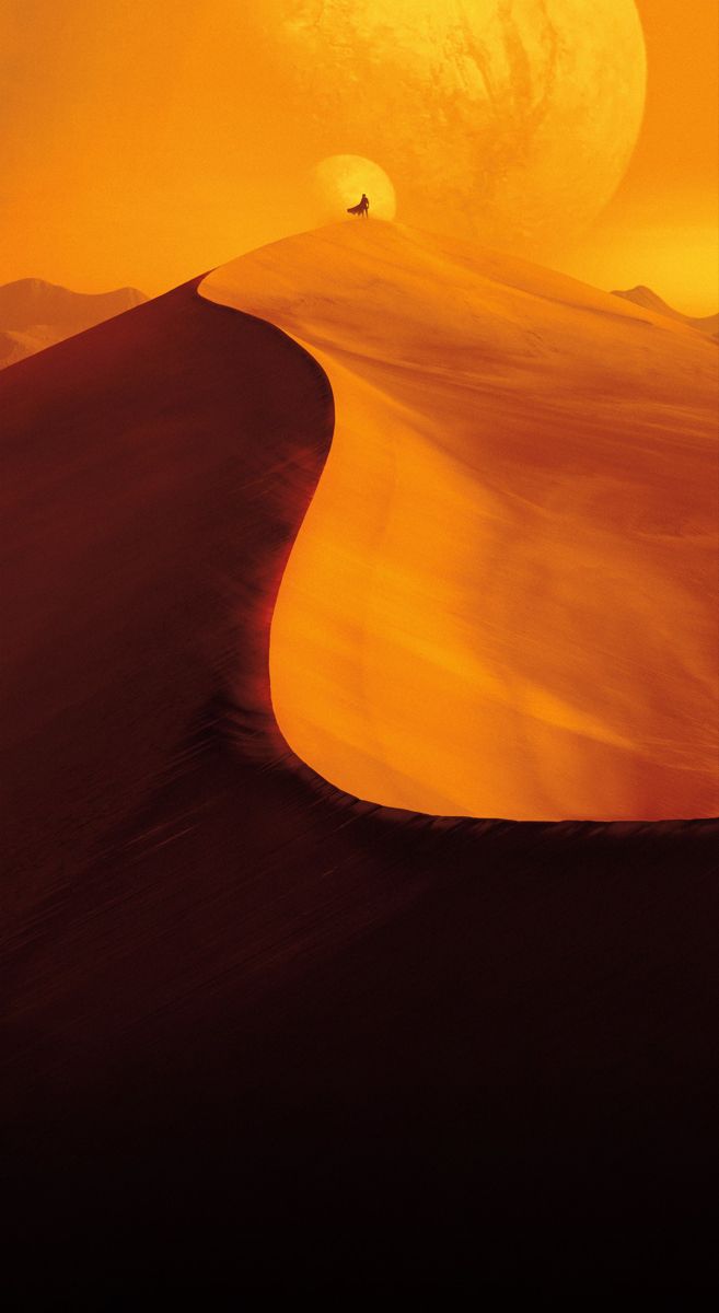 the sun is setting on top of a desert with sand dunes in front of it