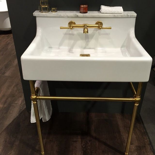 a white sink sitting on top of a wooden floor