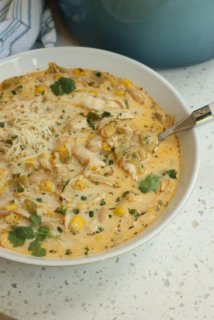 a white bowl filled with chicken and corn soup