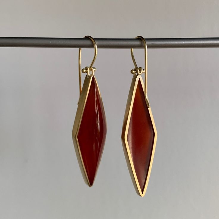 Rich vermillion color balances elegance with extravagance in these strikingly structured carnelians. 18k yellow gold Carnelian, 31.8ctw, 11mm x 38mm (7/16" x 1 1/2")Earrings hang 2 1/16" from the ear Each earring weighs 5.3g