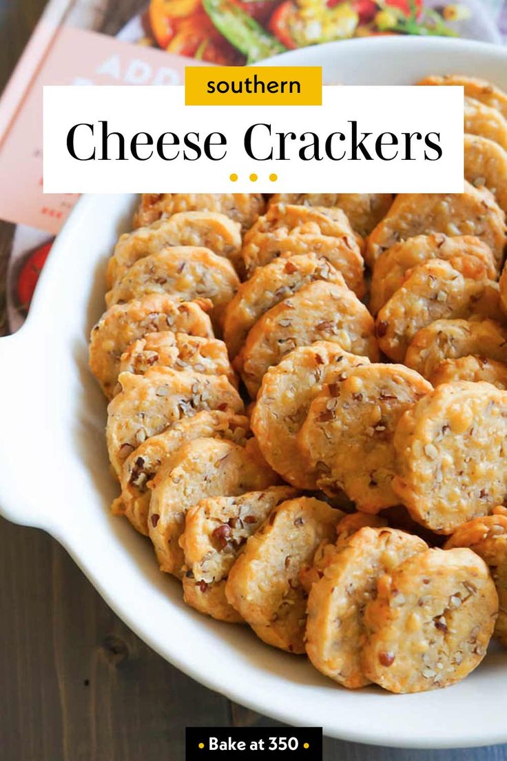 a white bowl filled with cheese crackers on top of a wooden table