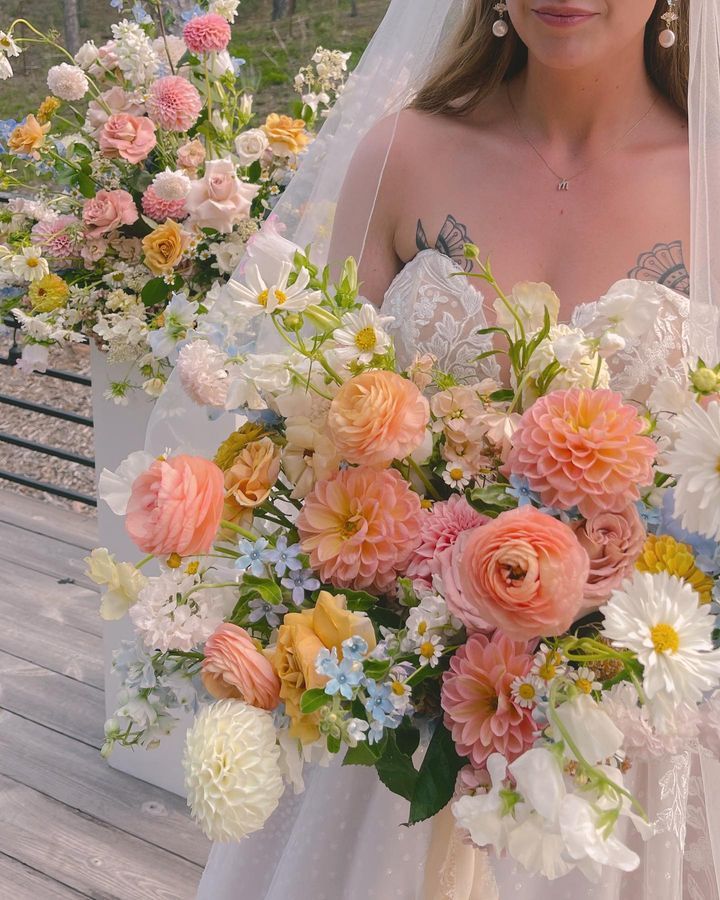 a woman in a wedding dress holding a bouquet of flowers