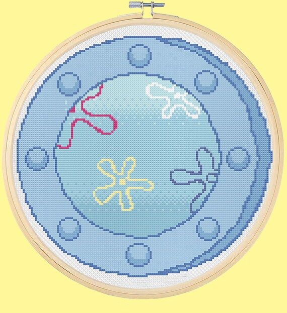 a cross stitch pattern with an image of a blue planet in the center and two small red objects on it