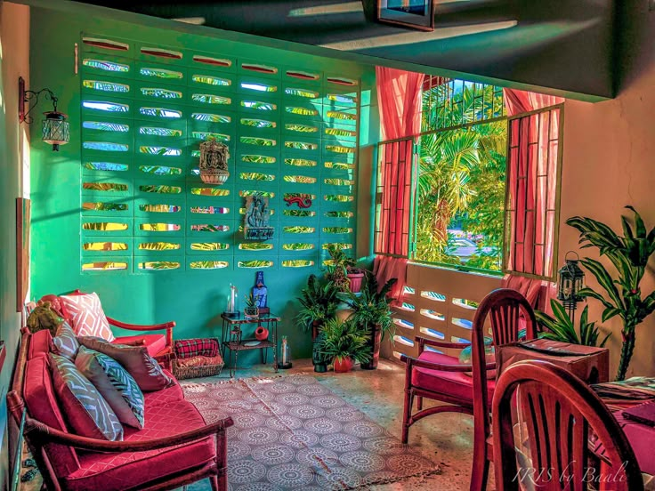 a living room filled with furniture next to a window covered in blinds and shades on the windows