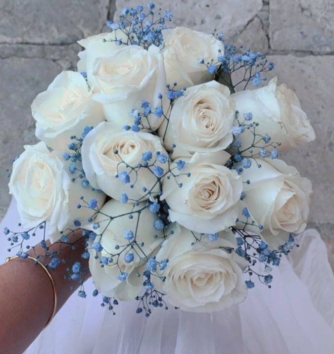 a bridal bouquet with white roses and baby's breath