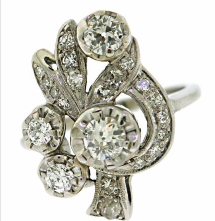 an antique style diamond ring with three stones on the front and center, set in white gold