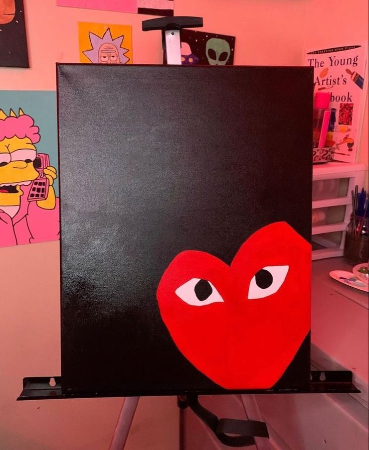 an easel with a heart painted on it in the shape of a cartoon character