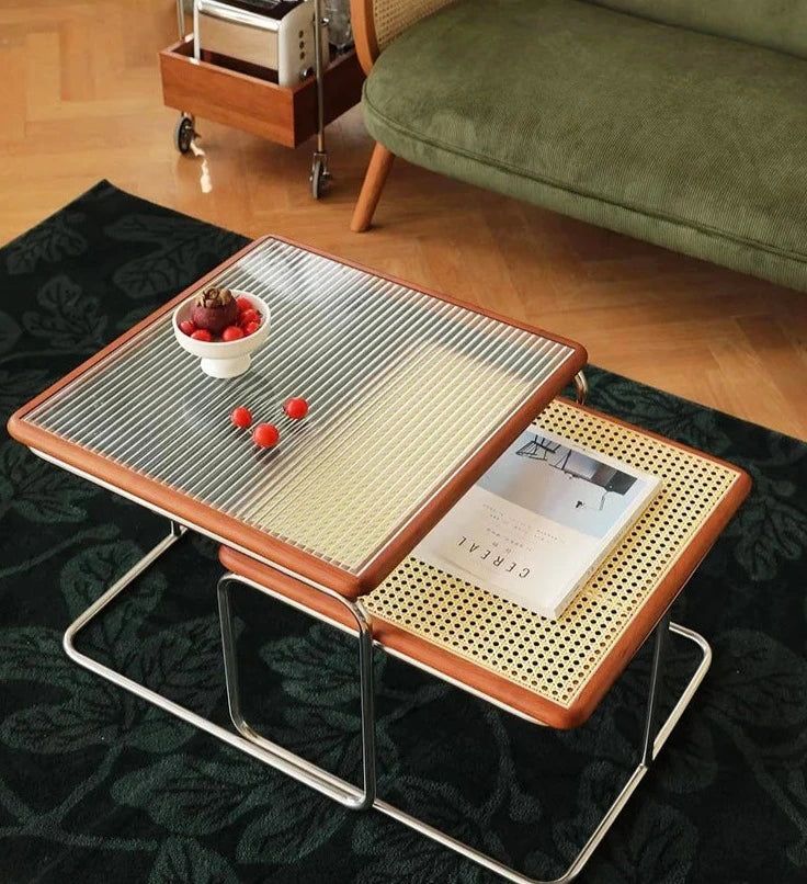 a coffee table with two trays on it and a bowl of cherries in the middle