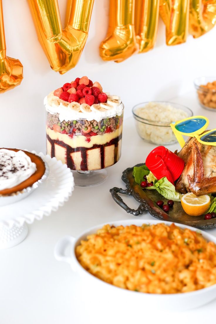 a table topped with cakes and other desserts