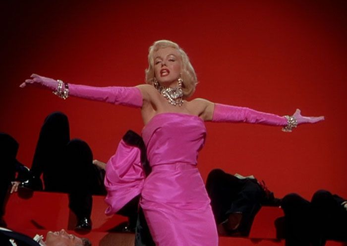 a woman in a pink dress with her arms spread out, and another photo of marilyn monroe