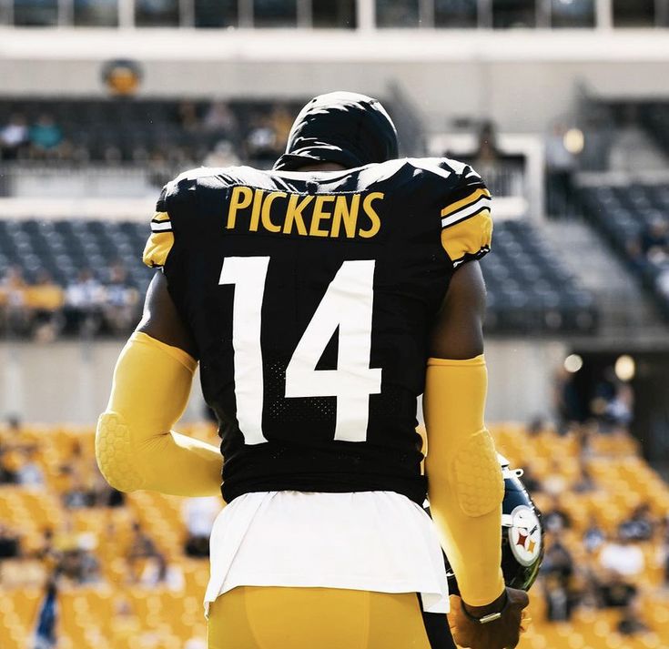 a football player wearing a black and yellow uniform