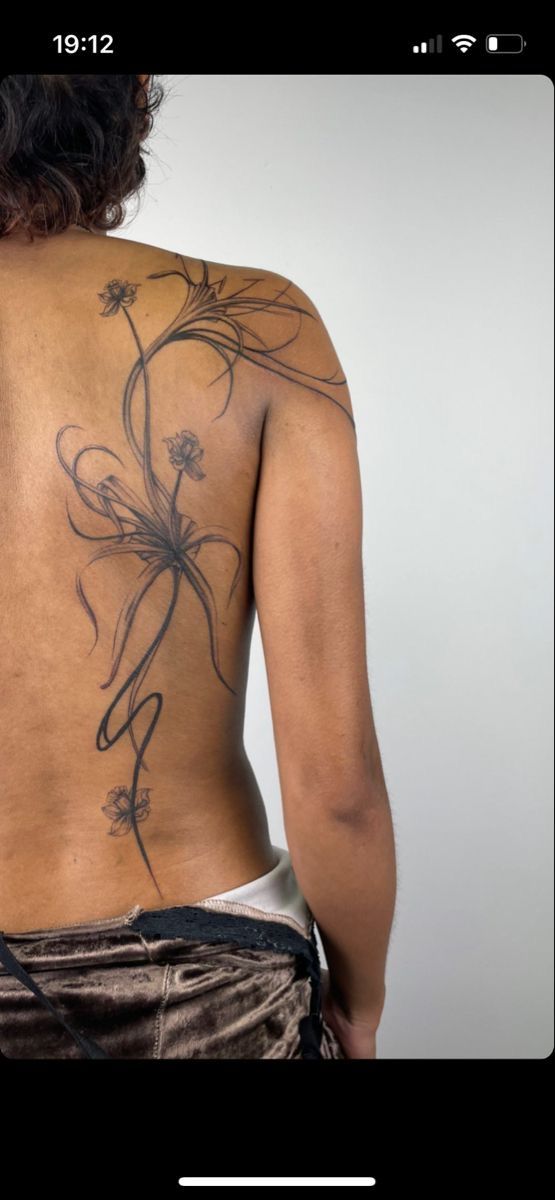 the back of a woman with tattoos on her body