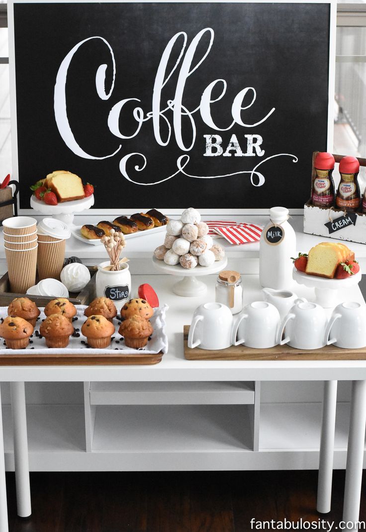 a coffee bar with cakes, muffins and cupcakes on the table