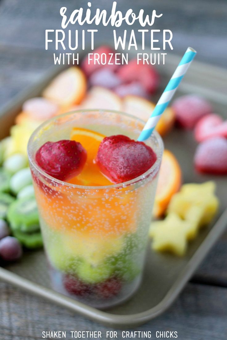 a glass filled with fruit sitting on top of a tray