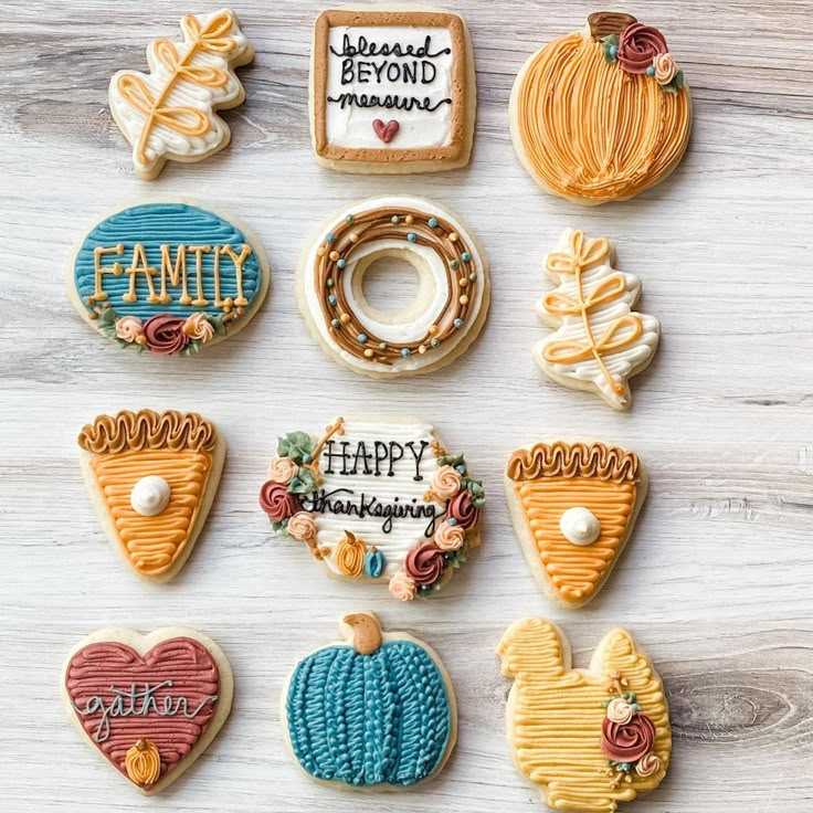 decorated cookies are arranged in the shape of heart, pumpkins, and other items