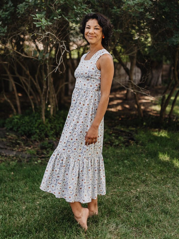 Our soft and stretchy organic cotton jersey is the perfect fabric for this midi dress. With a soft floral print, chic tiered hem, and feel-good wide straps, it's a dress that can go all day and carry you right into the evening. Jersey. 95% Organic Cotton 5% Spandex Length of size M is 42" from top of bodice Made fair trade in India by one of our longstanding production partners Sleeveless Cotton Tiered Dress For Day Out, Cotton Sleeveless Tiered Dress For Day Out, Garden Party Sleeveless Sundress Tiered Dress, Sleeveless Cotton Tiered Dress For Brunch, Casual Tiered Dress With Ruffled Straps For Garden Party, Casual Sundress With Ruffle Hem And Square Neck, Cotton Midi Dress With Ruffle Hem For Garden Party, Casual Cotton Maxi Dress With Ruffled Straps, Casual Cotton Tiered Sundress