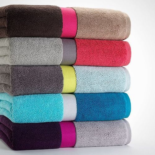 a stack of towels stacked on top of each other in different colors and sizes,