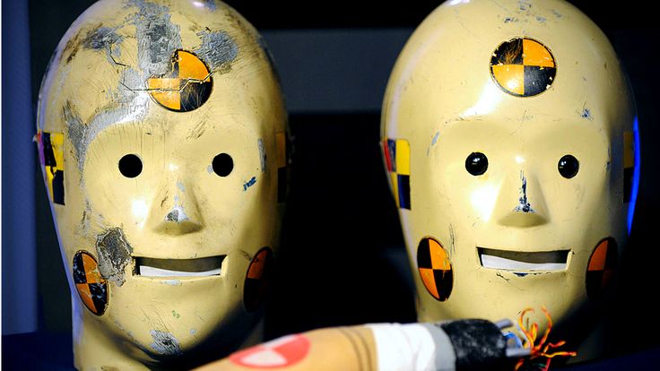 two white masks with faces on them sitting next to a paintbrush and toothpaste