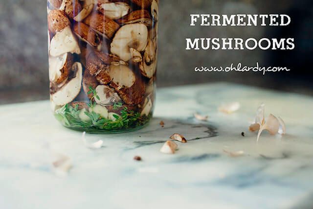 a jar filled with mushrooms sitting on top of a table