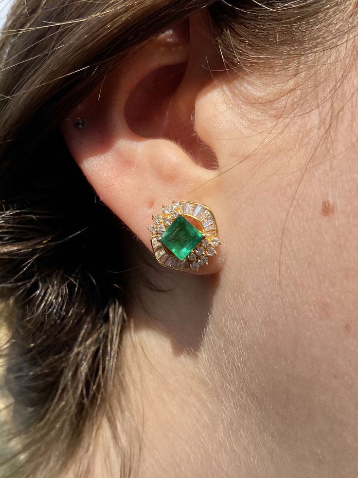 "Pacific Jewelry Presents, Vintage natural Colombian Emeralds, featuring two exquisite square cut Emeralds weighing approx. 1.70 carats (total) and adorned with lively colorless natural diamonds. Diamonds are an assortment of baguette and round cut, approx. 1.35 carats (total). These beautiful earrings are mounted in 18k yellow gold, and have a safe push back closure made in 14k gold for extra strength and durability. The Emeralds are of the highest quality and are untreated. The deep \"muzo gre Elegant Gemstone Baguette-cut Earrings, Gia Certified Classic Evening Jewelry, Classic Formal Emerald Earrings, Classic Green Diamond Earrings, Luxury Yellow Gold Cluster Earrings With Gemstones, Classic Emerald Earrings For Formal Occasions, Luxury Gia Certified Yellow Gold Earrings, Gia Certified Luxury Yellow Gold Earrings, Luxury Gia Certified Yellow Gold Diamond Earrings