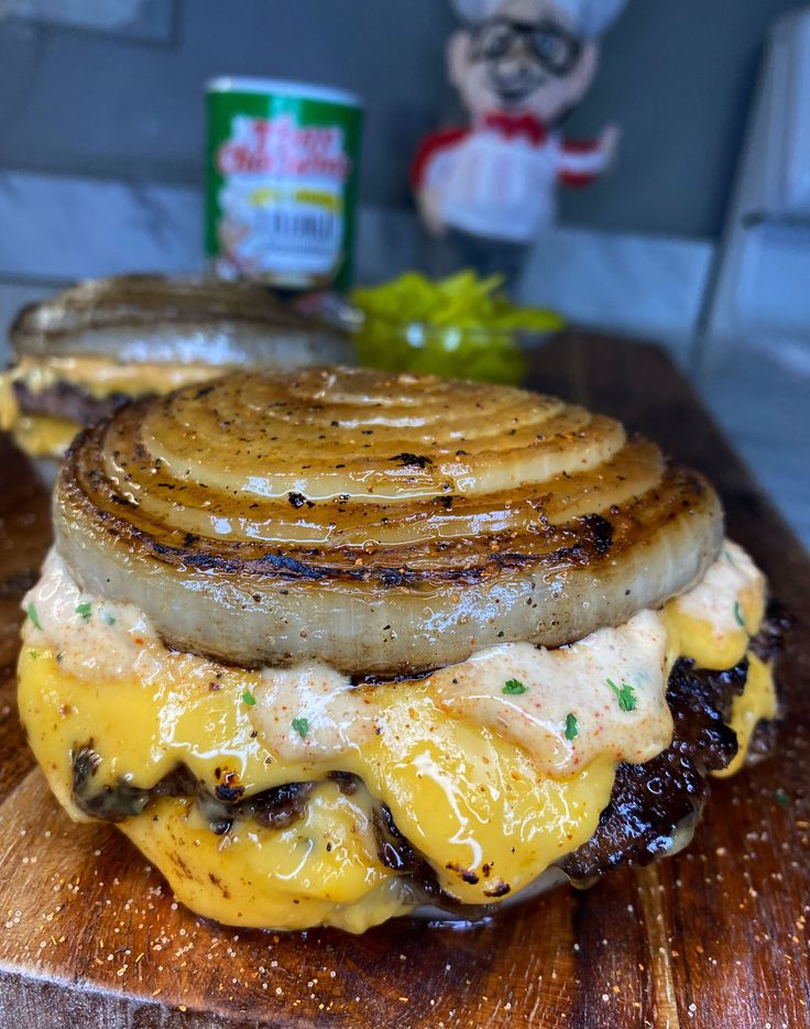 a grilled cheese and onion sandwich on a wooden cutting board