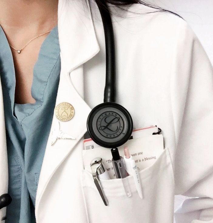 a woman wearing a white coat with a black stethoscope in her pocket