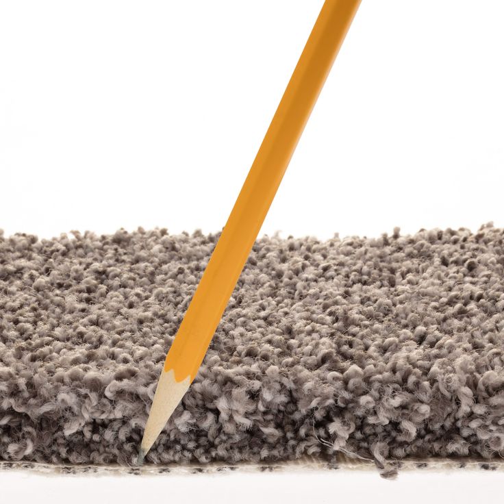 a pencil sticking out of the middle of a carpet