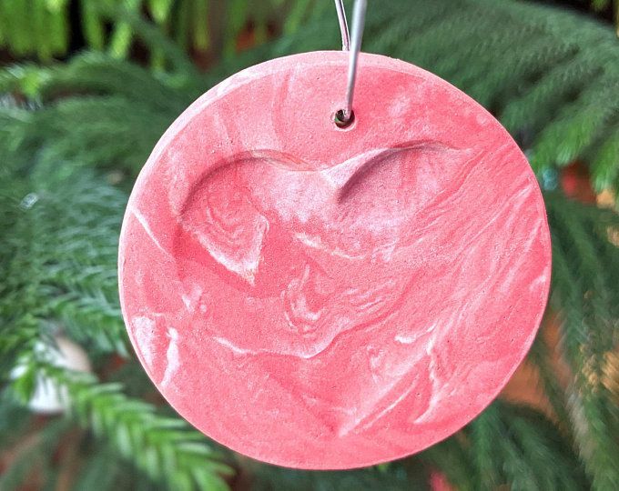 a pink ornament hanging from a christmas tree