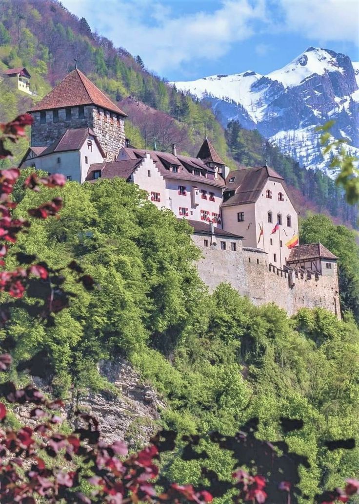 an old castle sits on top of a mountain