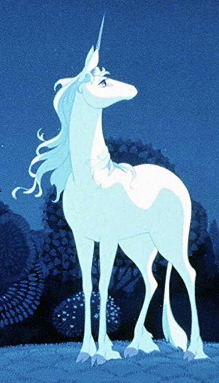 a white unicorn standing in the middle of a forest