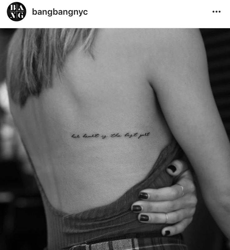 the back of a woman's shoulder with an inscription on it