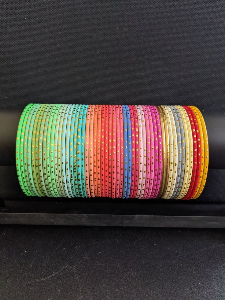 2x4, 2x6 and 2x8 size Indian Bangles. A set includes 12 bangles. Base material is made of aluminium and then color coated. Matte finish top with gold dot and with shiny inner finish colorful bangles. 2.25 inches is commonly referred as 2x4 Indian size. 2.37 inches is commonly referred as 2x6 Indian size. 2.5 inches is commonly referred as 2x8 Indian size. Please allow some variation in color. Match your outfits with these colorful trendy bangles. **If you need to buy in bulk, please message us. Metal Bangles, Colorful Bangles, Indian Bangles, Silk Thread Bangles, Gold Dot, Plastic Pouch, Thread Bangles, Bangles Indian, Indian Wedding Jewelry