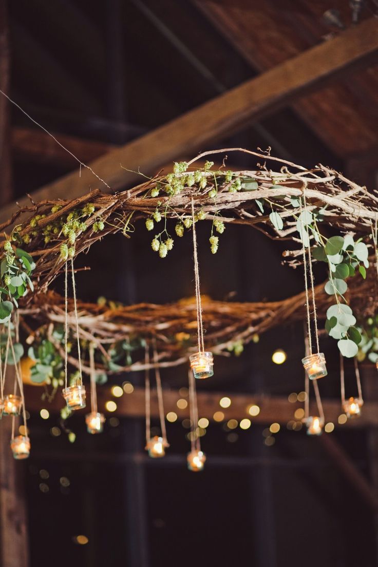 an image of some lights hanging from the ceiling with greenery on them and other decorations